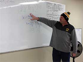 Teacher writing on white board